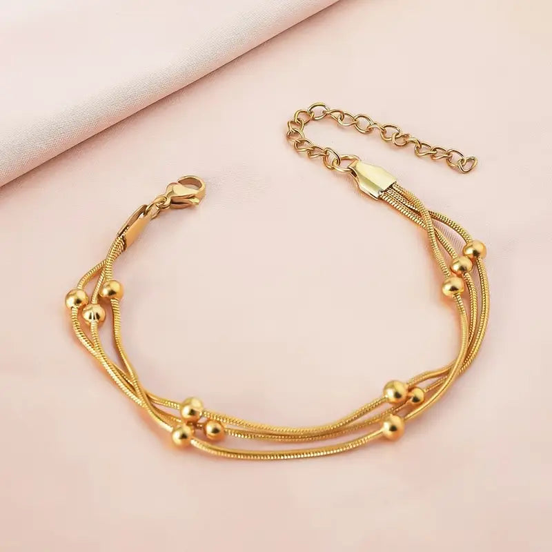 Pulsera Mútiple Cadena Serpiente y Cuencas Doradas