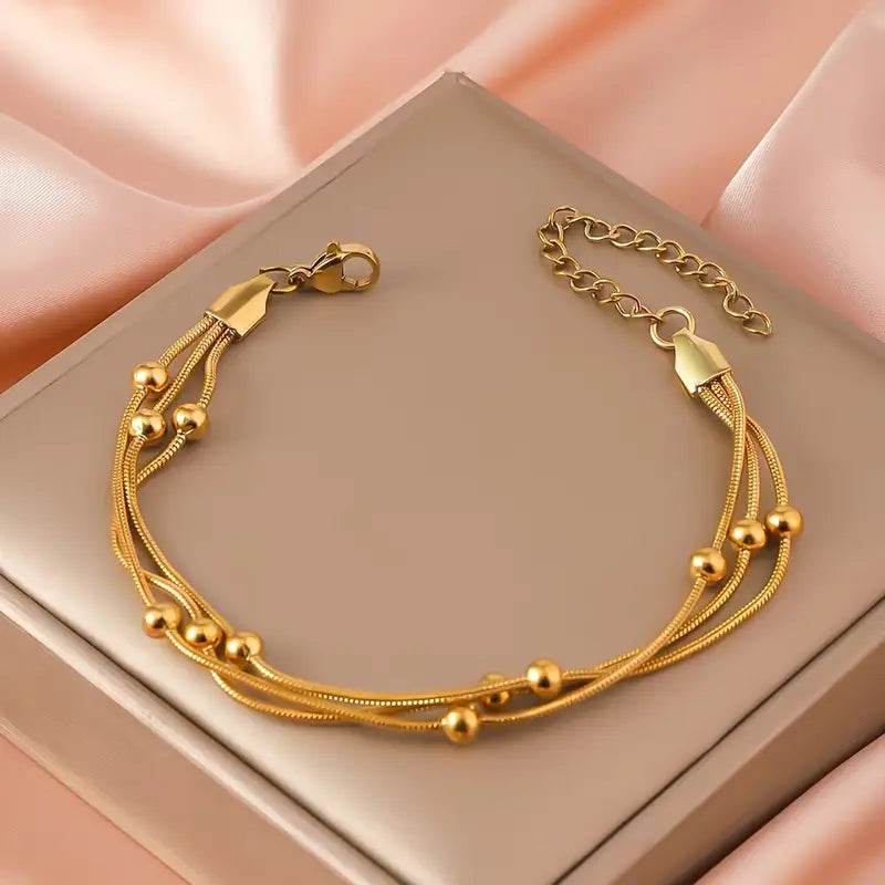 Pulsera Mútiple Cadena Serpiente y Cuencas Doradas