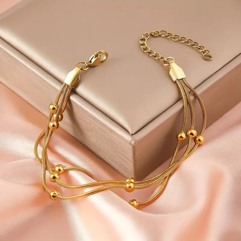 Pulsera Mútiple Cadena Serpiente y Cuencas Doradas